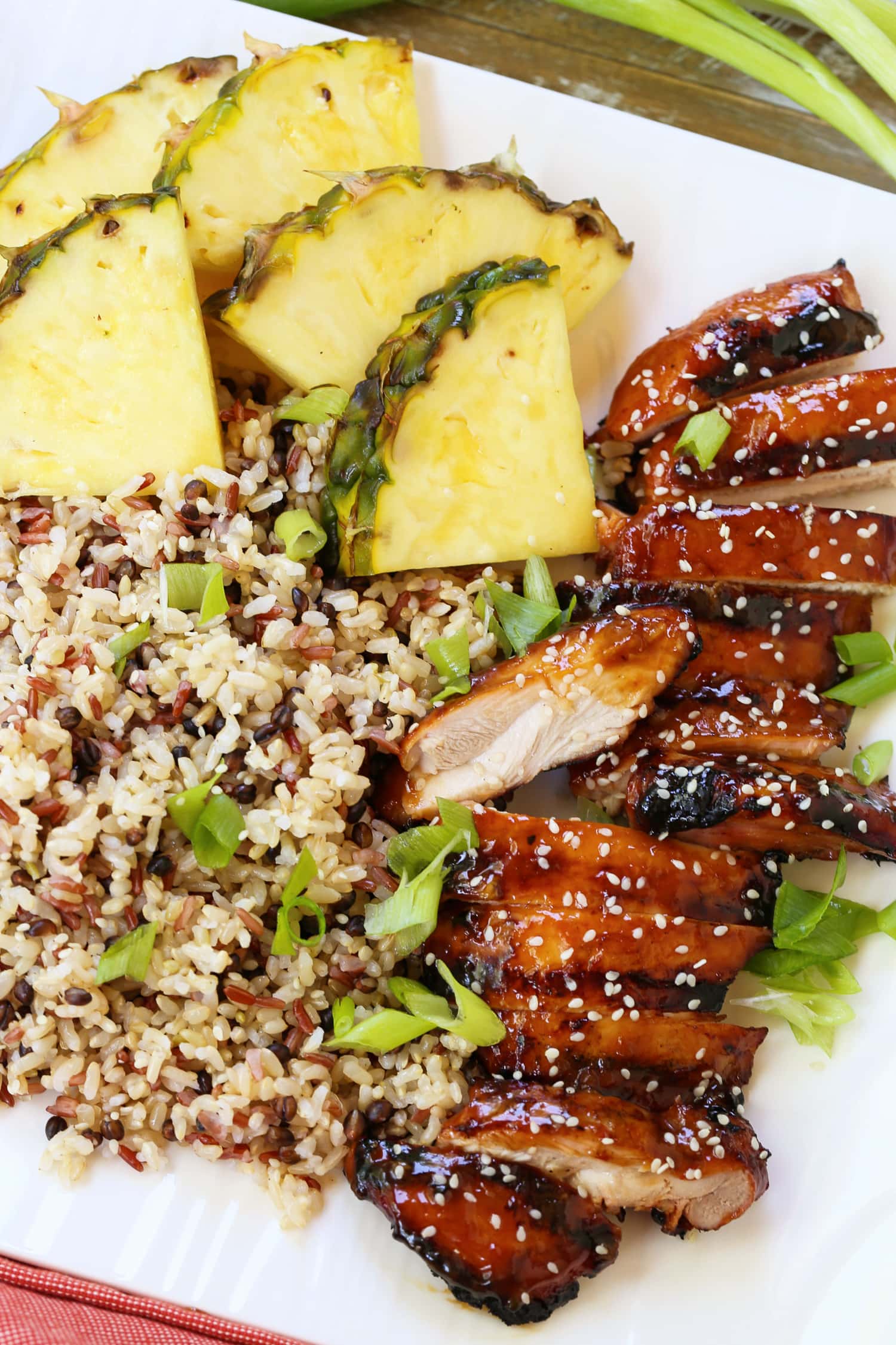 teriyaki chicken sliced on platter with pineapple