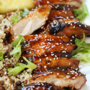 sliced teriyaki chicken with sesame seeds and scallions