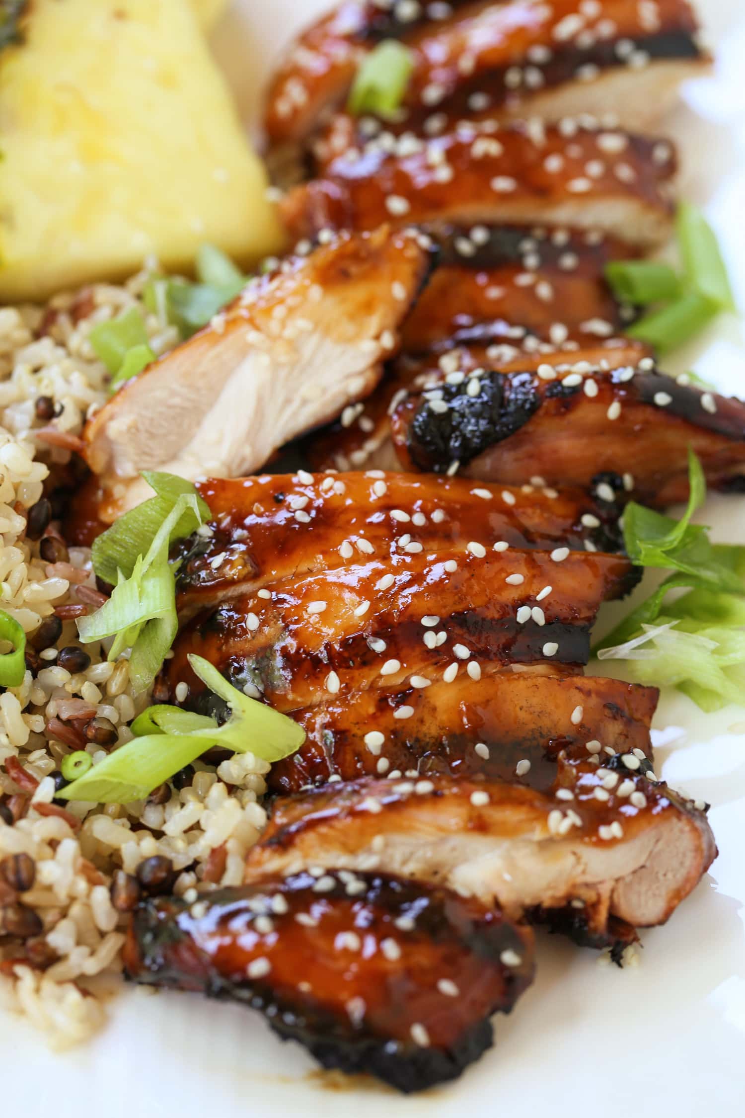 sliced teriyaki chicken with sesame seeds and scallions