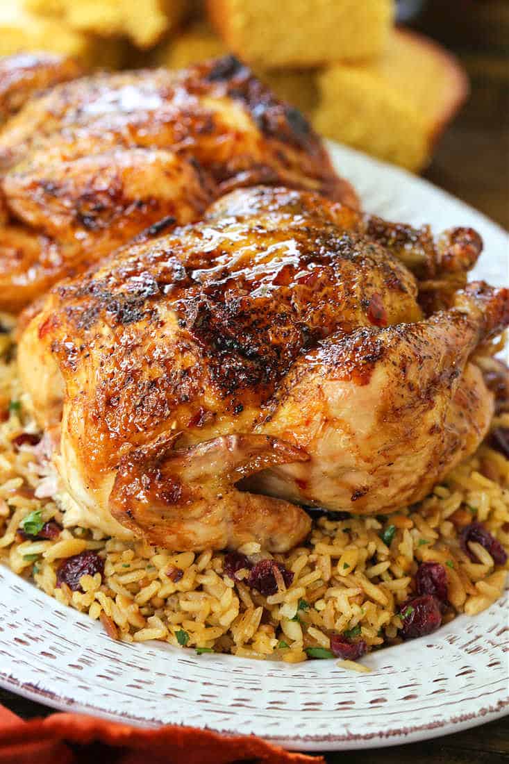 Cornish hens on a serving platter with rice pilaf