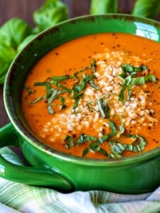 tomato basil soup with parmesan cheese and basil on top