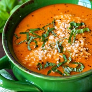 tomato basil soup with parmesan cheese and basil on top