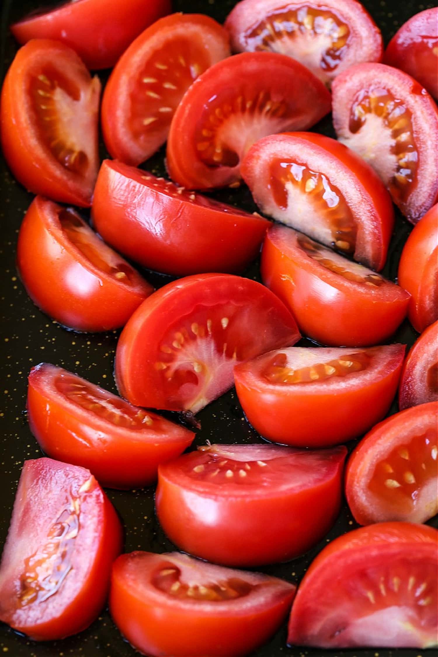 fresh tomato wedges on sheet pan