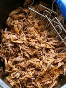 pulled pork in a slow cooker with meat claws