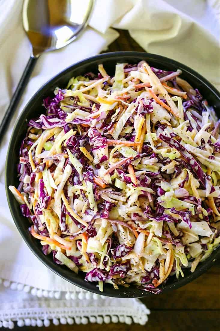 coleslaw in a bowl with spoon