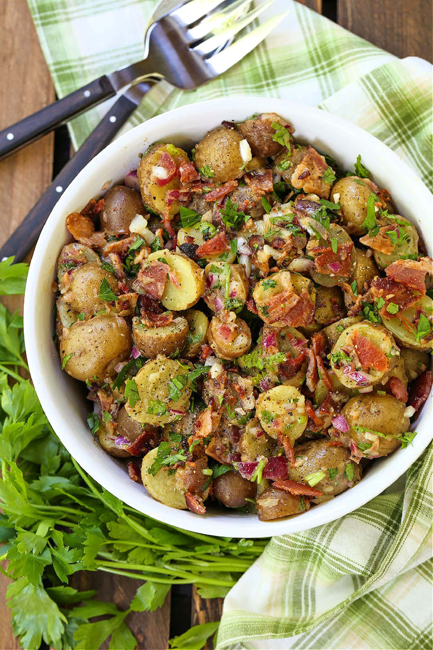 german potato salad in bowl with fork and spoon