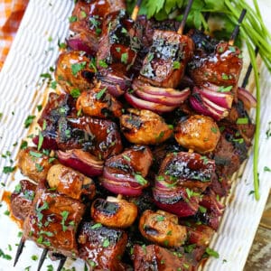 steak kabobs stacked on a platter