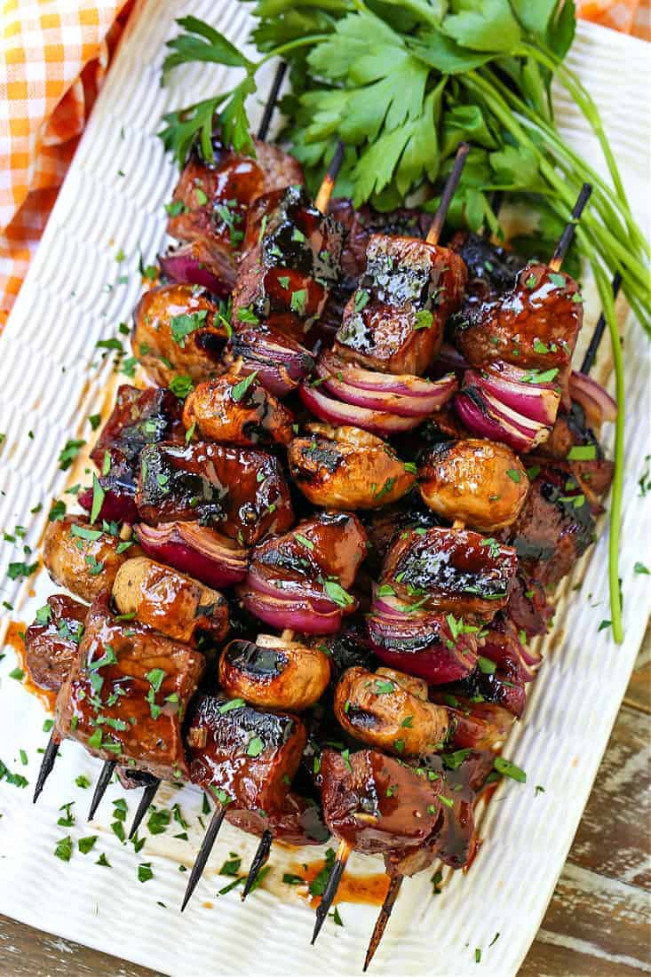 steak kabobs stacked on a platter