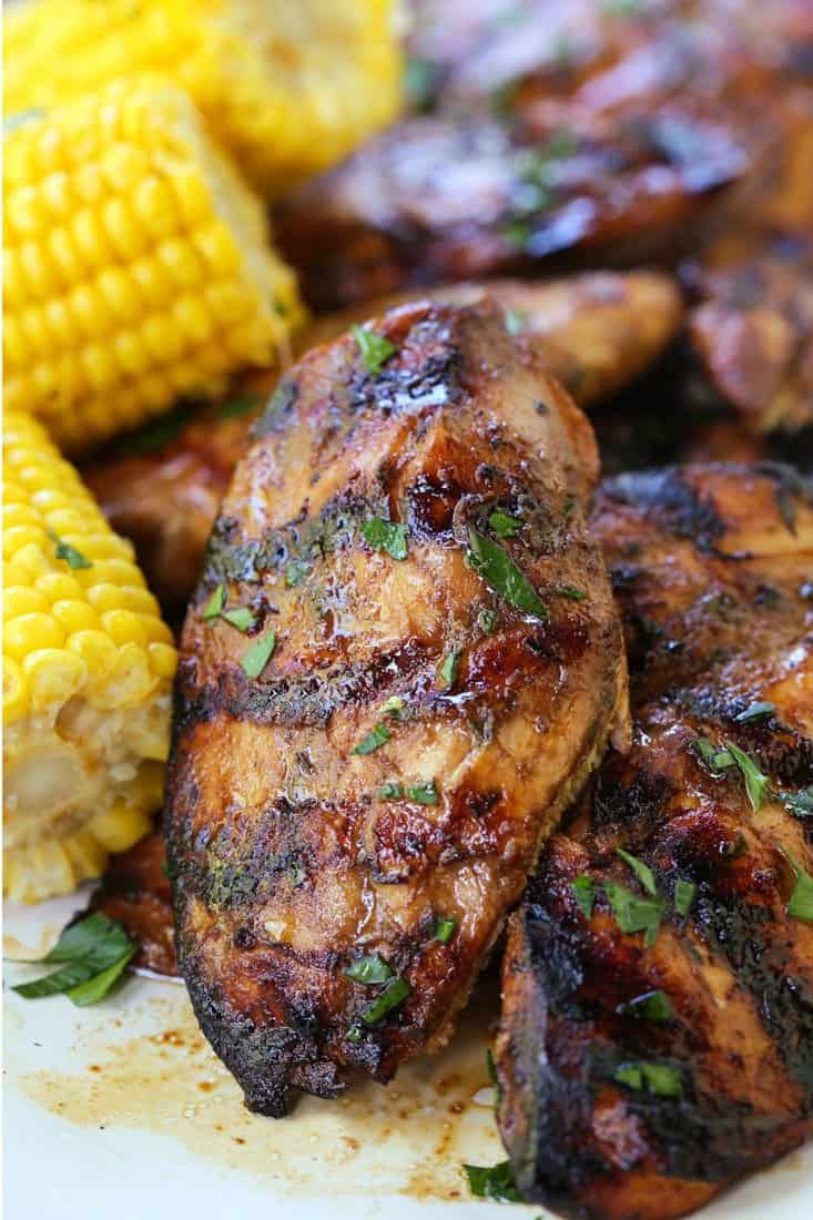 grilled chicken breast on a plate with corn