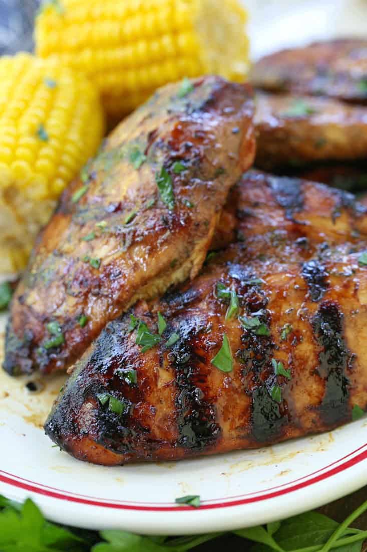 Grilled chicken breast recipe on a plate with corn