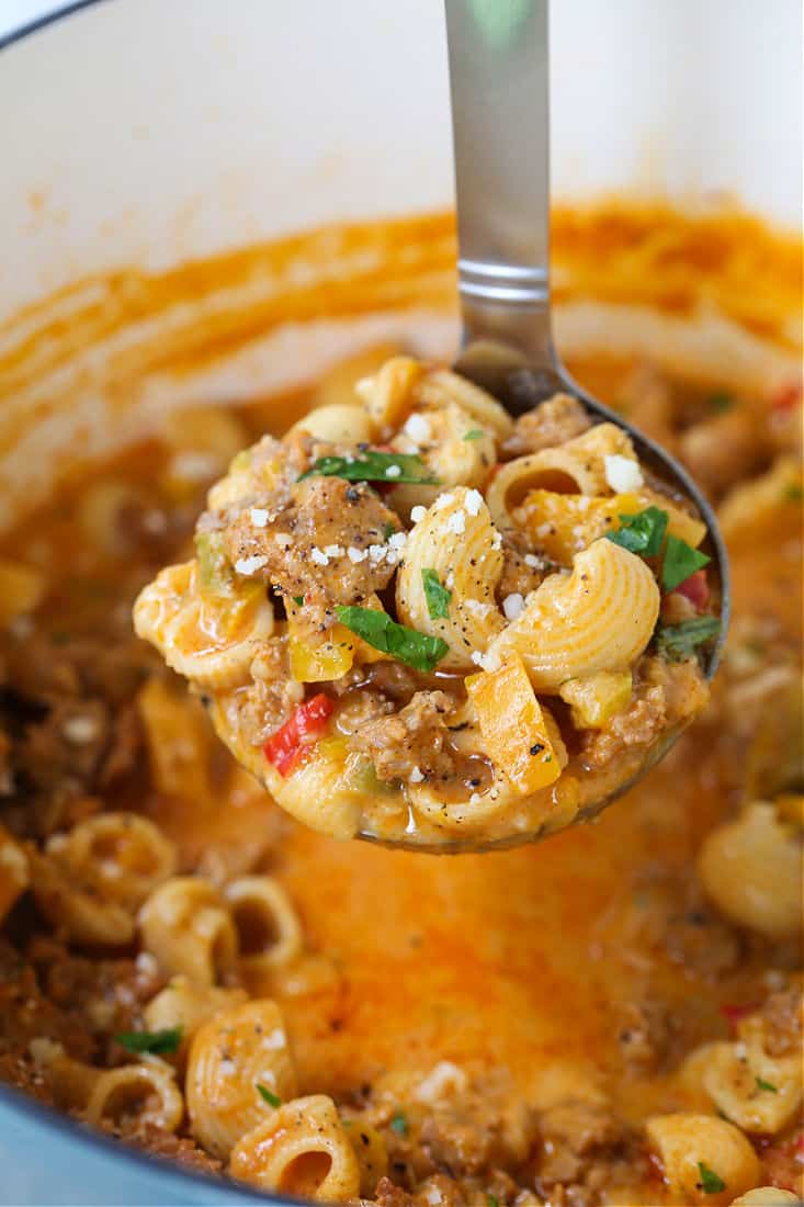 Sausage and peppers soup on a ladle