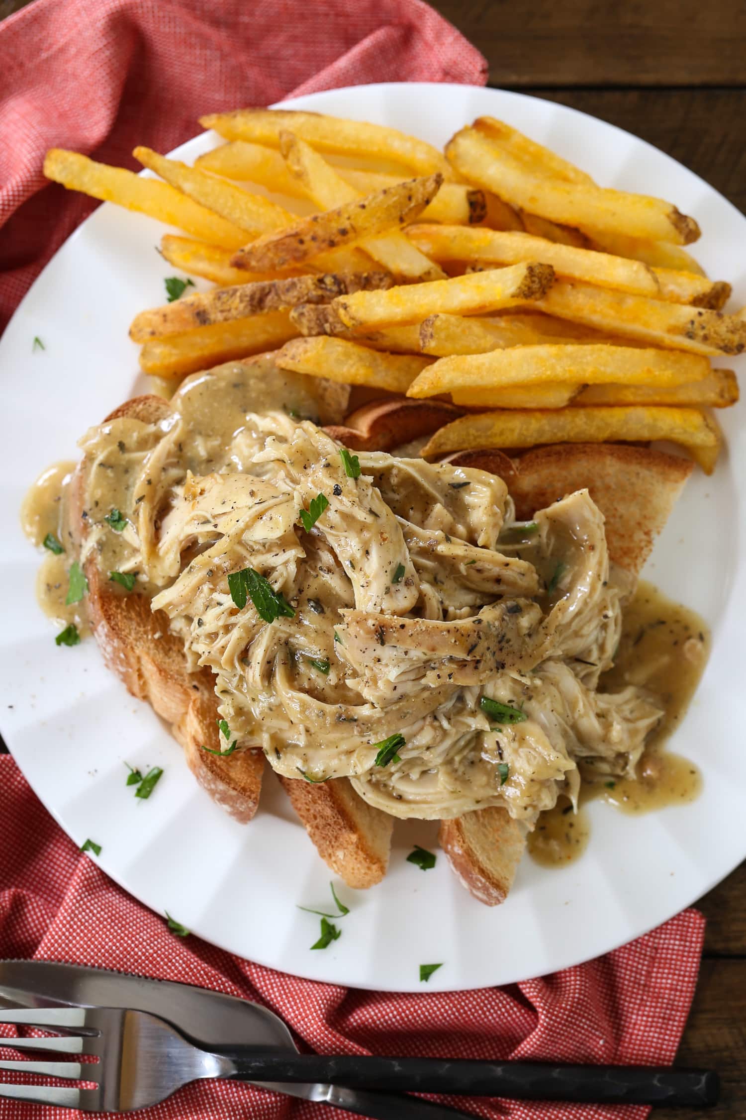 shredded chicken with gravy on toast with fries