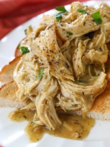 crock pot chicken and gravy spooned over toast