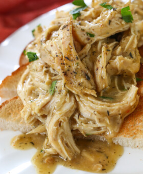 crock pot chicken and gravy spooned over toast