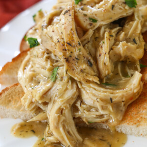 crock pot chicken and gravy spooned over toast