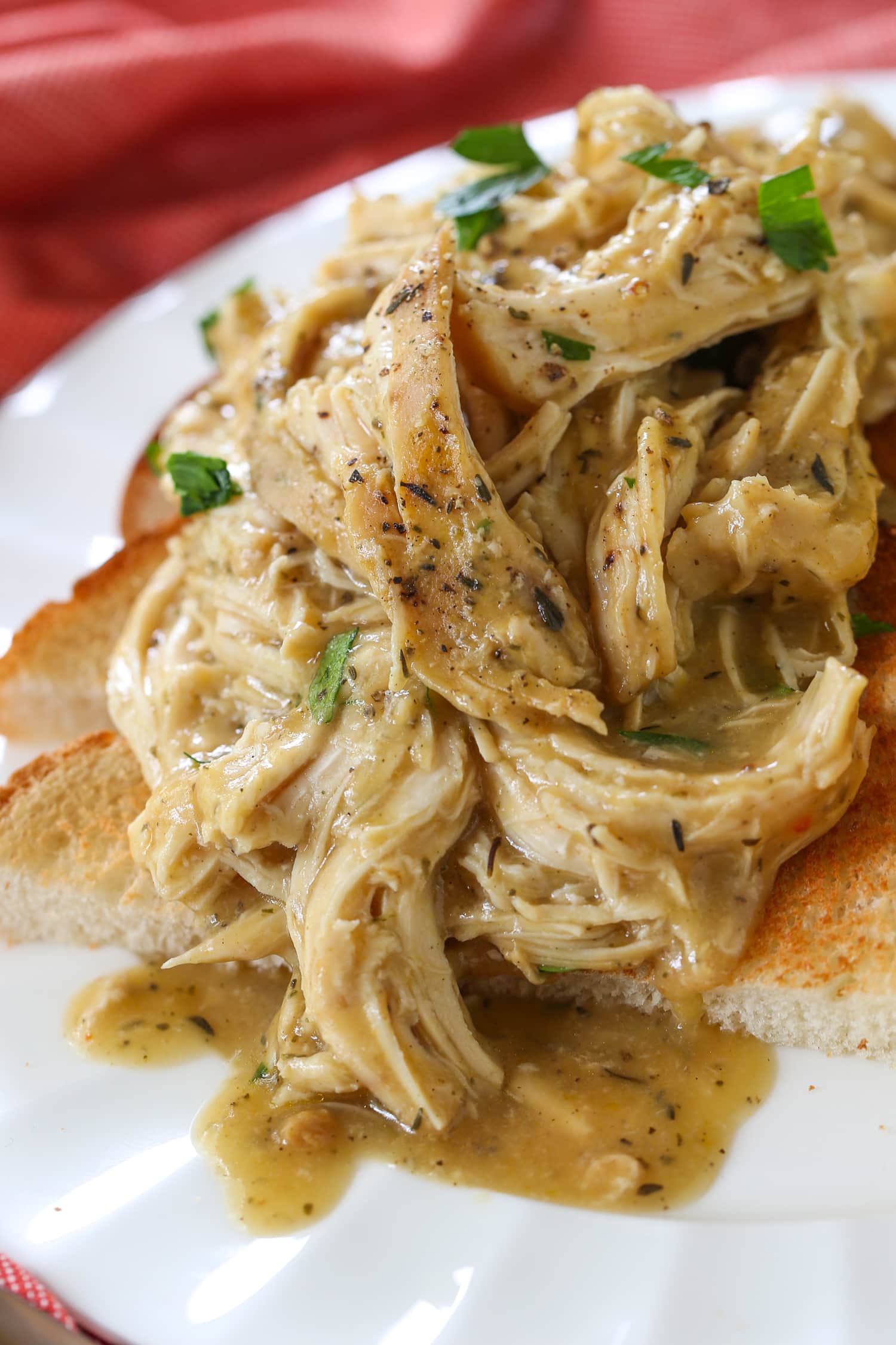 crock pot chicken and gravy spooned over toast