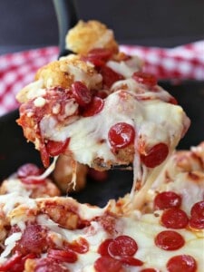 Pepperoni Pizza Totchos being served with a spoon