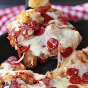 Pepperoni Pizza Totchos being served with a spoon