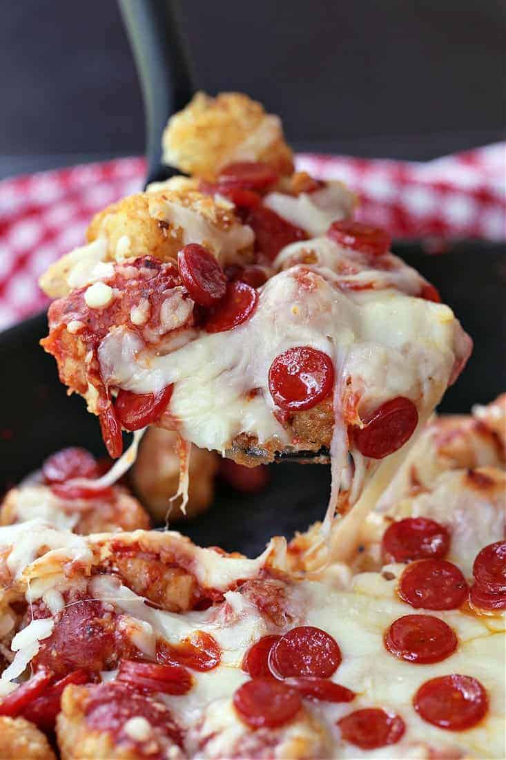 Pepperoni Pizza Totchos being served with a spoon