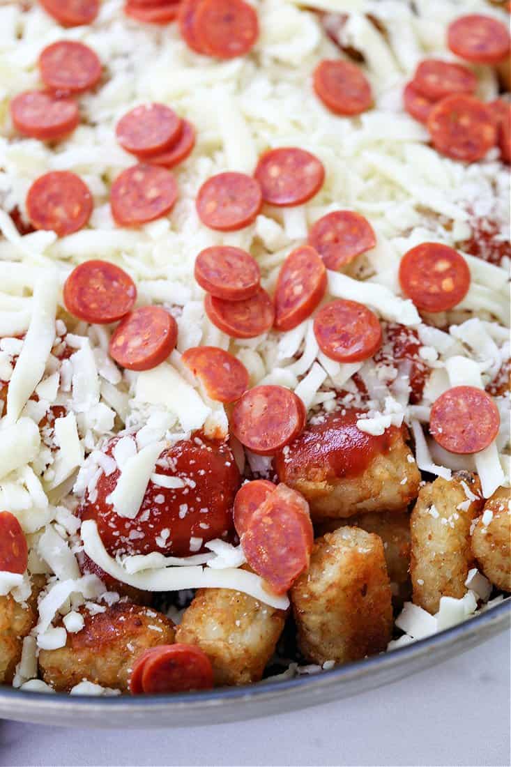 Pile on all your favorite pizza toppings when your making these fun Pepperoni Pizza Totchos! before going into the oven