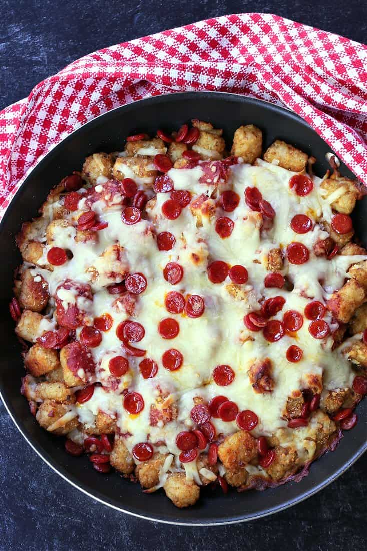 Pizza Totochos in a skillet with checkered napkin