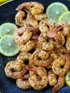 Lemon Pepper Shrimp made in an air fryer on a black plate