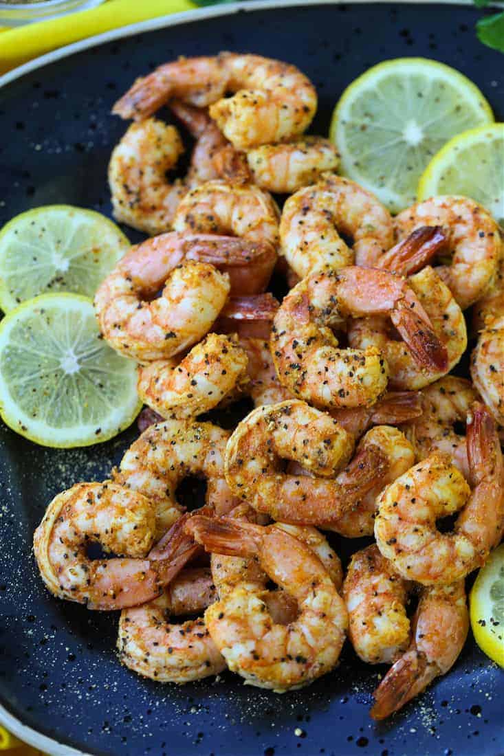 Lemon Pepper Shrimp made in an air fryer on a black plate