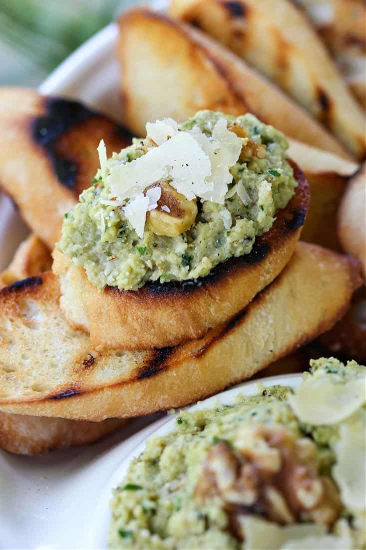 Artichoke pesto with walnuts and parmesan cheese on a piece of toasted bread