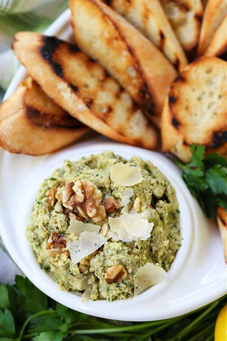 Walnut pesto with artichokes and parmesan cheese in a serving dish