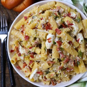 Rigatoni with bacon and brussels sprouts in a bowl with forks