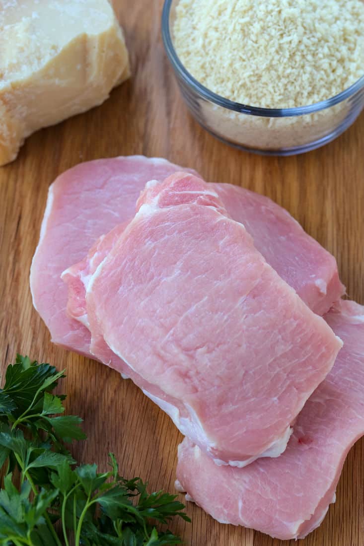 Ingredients for baked pork chop recipe on a wooden board