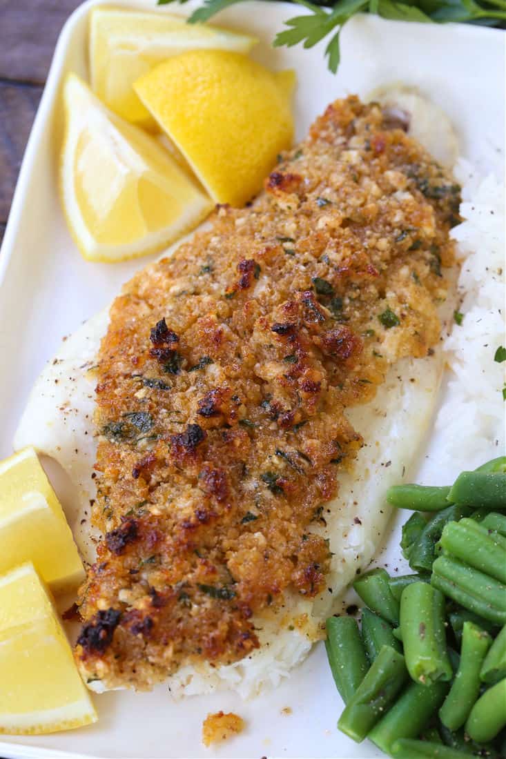 Parmesan Crusted Haddock on a plate with green beans and rice