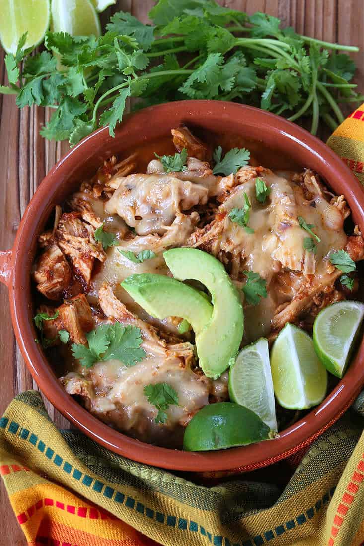 Slow Cooker Taco Chicken in a bowl with limes