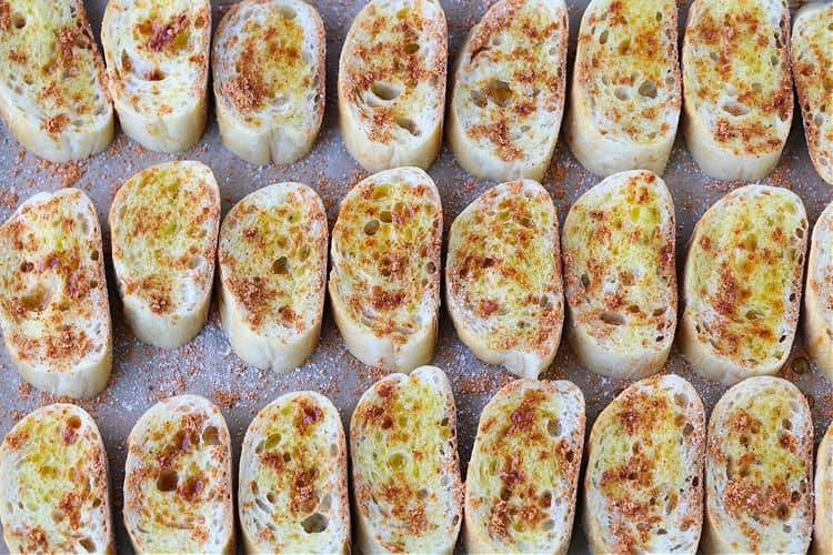 slices of bread on a sheet pan to make crostini