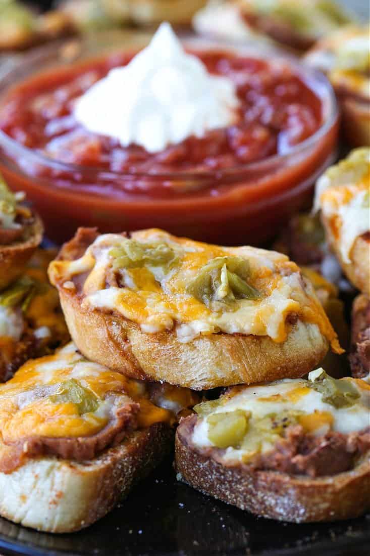 Cheese crostini appetizer on a platter with salsa