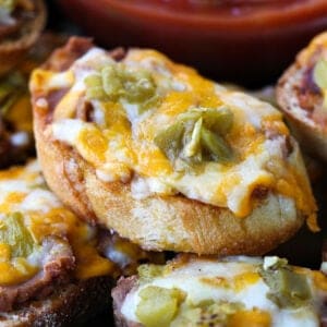 Cheese melted on toast with refried beans and green chilis