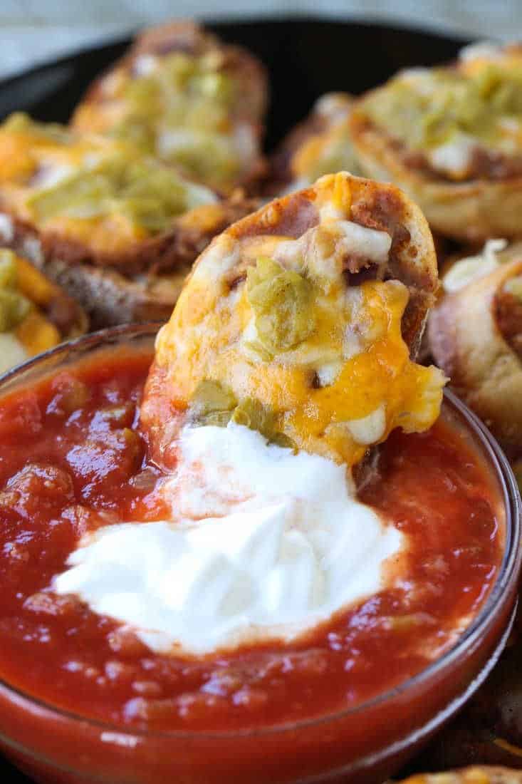 Cheesy crostini dipped into salsa and sour cream