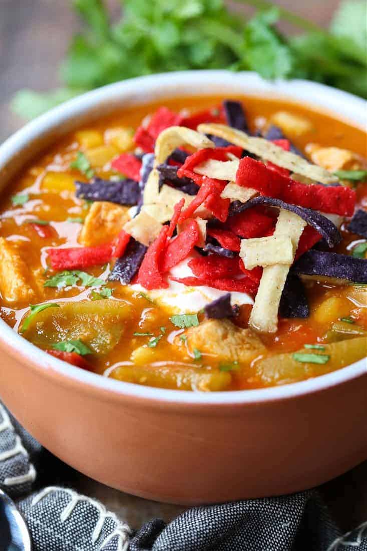 Chicken Fajita Soup in a bowl with napkin and spoons