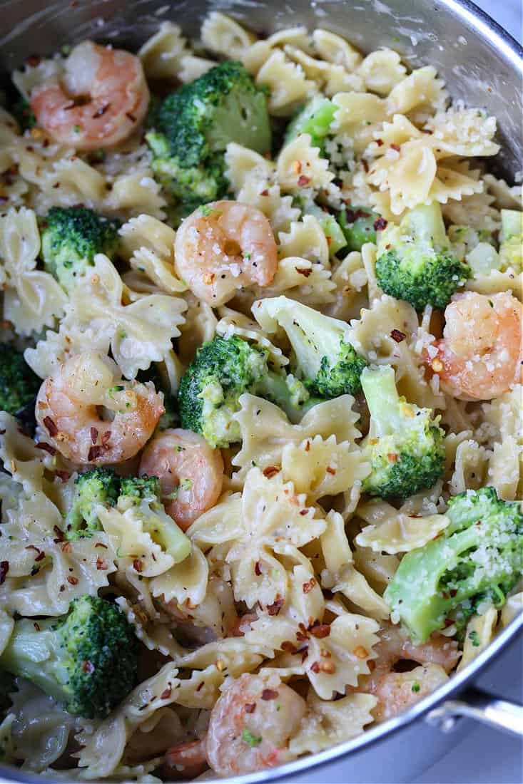 Bowties and broccoli in a pot with shrimp