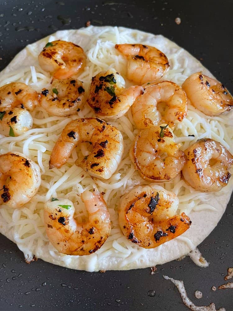 shrim and cheese on a tortilla for a quesadilla recipe