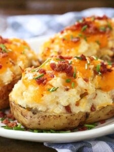 Twice Baked potatoes on a plate with checkered napkin