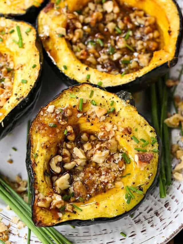 With a buttery texture and a golden caramelized crust, Acorn Squash with Brown Sugar and Walnuts features a sweet and nutty filling. Two halves of an acorn squash hollowed out and filled with nuts.