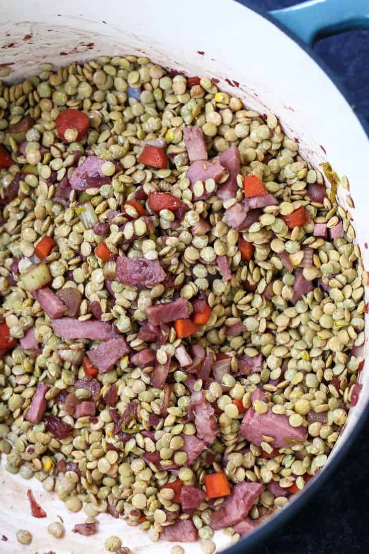 Lentils in a soup pot with vegetables and ham