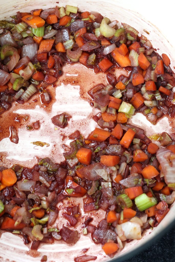 diced vegetables in a soup pot deglazed with red wine