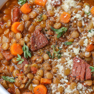 lentil soup with ham in a bowl with parmesan cheese and fresh thyme