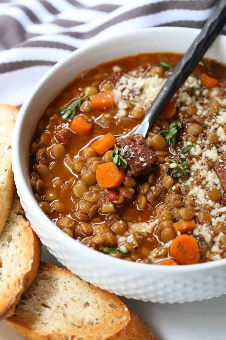 Lentil Soup with Ham in a bowl with a spoon and parmesan cheese