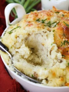 Potatoes Romanoff in a baking dish with spoon