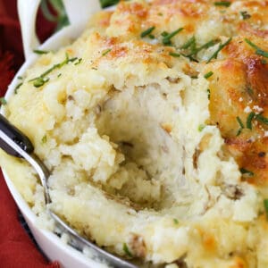 Potatoes Romanoff in a baking dish with spoon