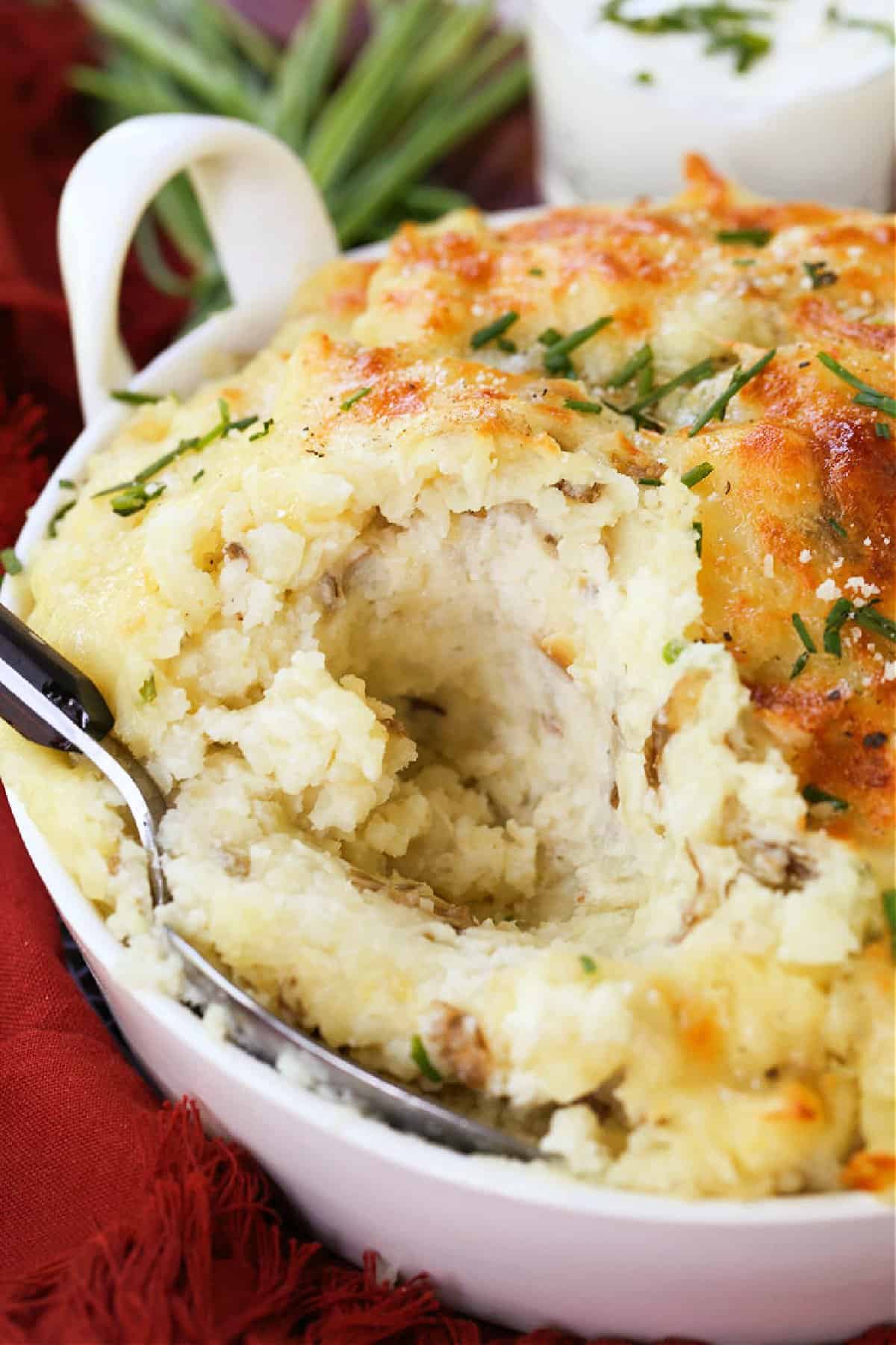 Potatoes Romanoff is a light and fluffy potato casserole with a unique cooking method! A make ahead side dish for parties and holidays! spoon in mashed potatoes with sour cream in background