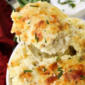 spoon serving a scoop of potato casserole